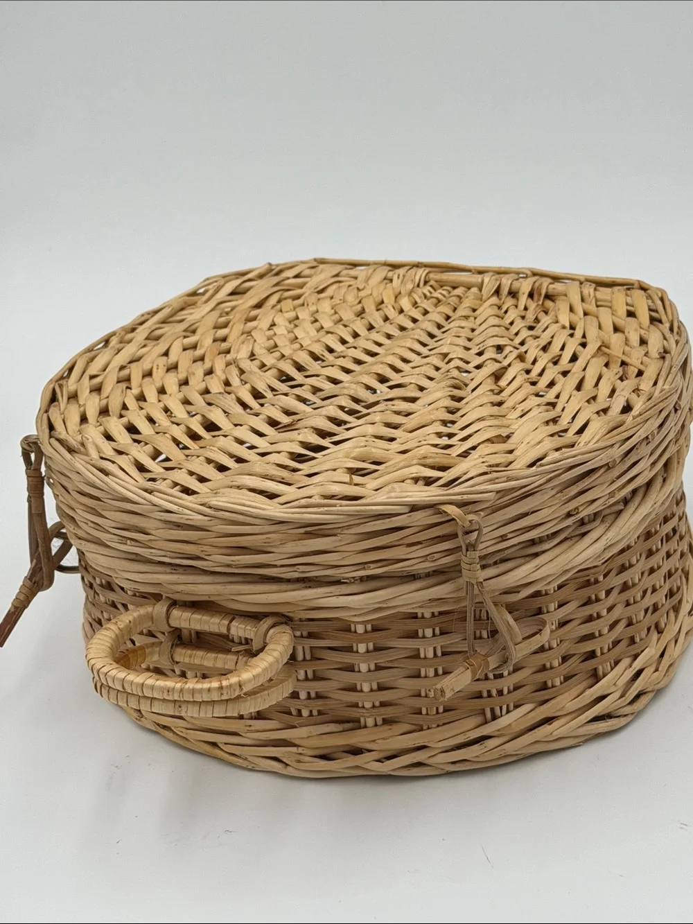 A Cute, charming vintage shell-shaped rattan storage basket with a front handle.